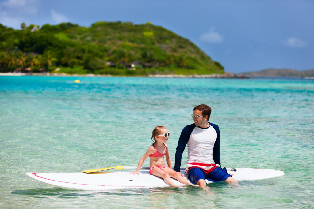 Caribbean life - A man and daughter in the beach